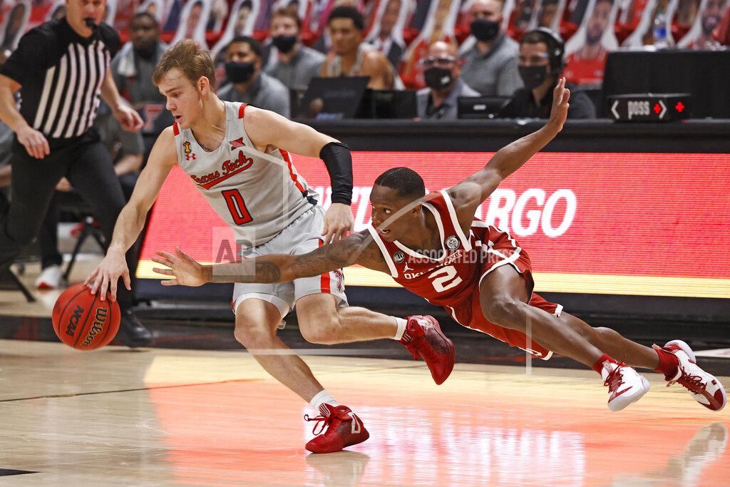 Brad Tollefson Oklahoma's Umoja Gibson (2) tries to steal the ball from Texas Tech's Mac McClung (0) during the second half of an NCAA college basketball game Monday, Feb. 1, 2021, in Lubbock, Texas. (AP Photo/Brad Tollefson)