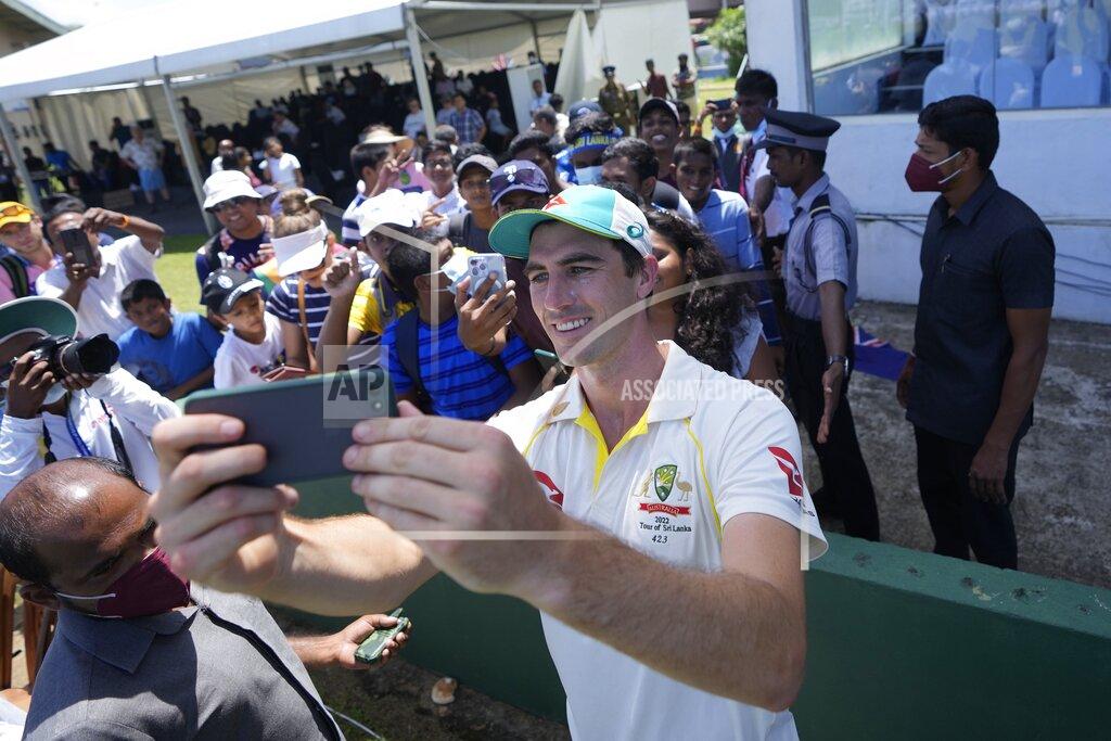 Eranga Jayawardena Australia's cricket captain Pat Cummins take selfie photos with fans after defeating Sri Lanka by ten wickets win in day three of the first test cricket match between Australia and Sri Lanka in Galle, Sri Lanka, Friday, July 1, 2022. (AP Photo/Eranga Jayawardena)
