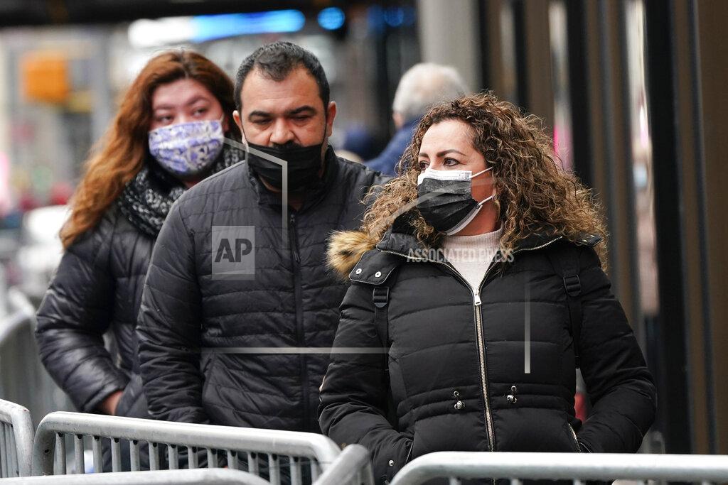 Frank Franklin Ii Pedestrians wear protective masks during the coronavirus pandemic in Times Square Thursday, Dec. 31, 2020, in New York. (AP Photo/Frank Franklin II)