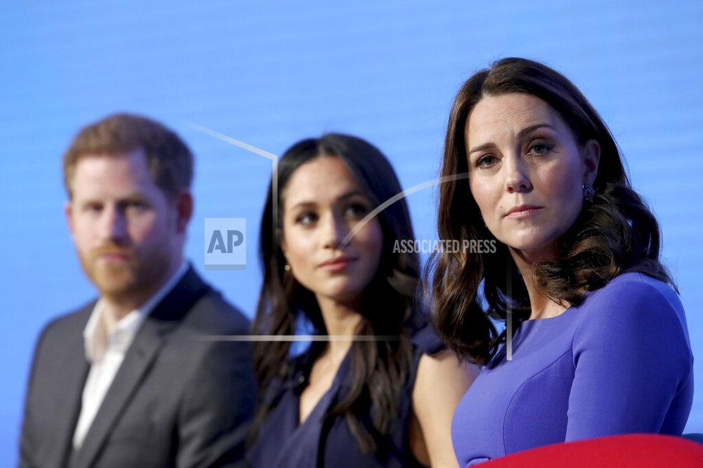 Chris Jackson FILE - In this Wednesday, Feb. 28, 2018 file photo, Britain's Kate, Duchess of Cambridge, right, with Prince Harry and his fiancee Meghan Markle attend the first annual Royal Foundation Forum in London. Britain and its royal family are absorbing the tremors from a sensational television interview with Prince Harry and Meghan. The couple said they encountered racist attitudes and a lack of support that drove Meghan to thoughts of suicide. The couple gave a deeply unflattering depiction of life inside the royal household, depicting a cold, uncaring institution that they had to flee to save their lives. Meghan told Oprah Winfrey that at one point “I just didn’t want to be alive anymore.” Meghan, who is biracial, said that when she was pregnant with son Archie, there were “concerns and conversations about how dark his skin might be when he’s born.”. (Chris Jackson/Pool via AP, FIle)