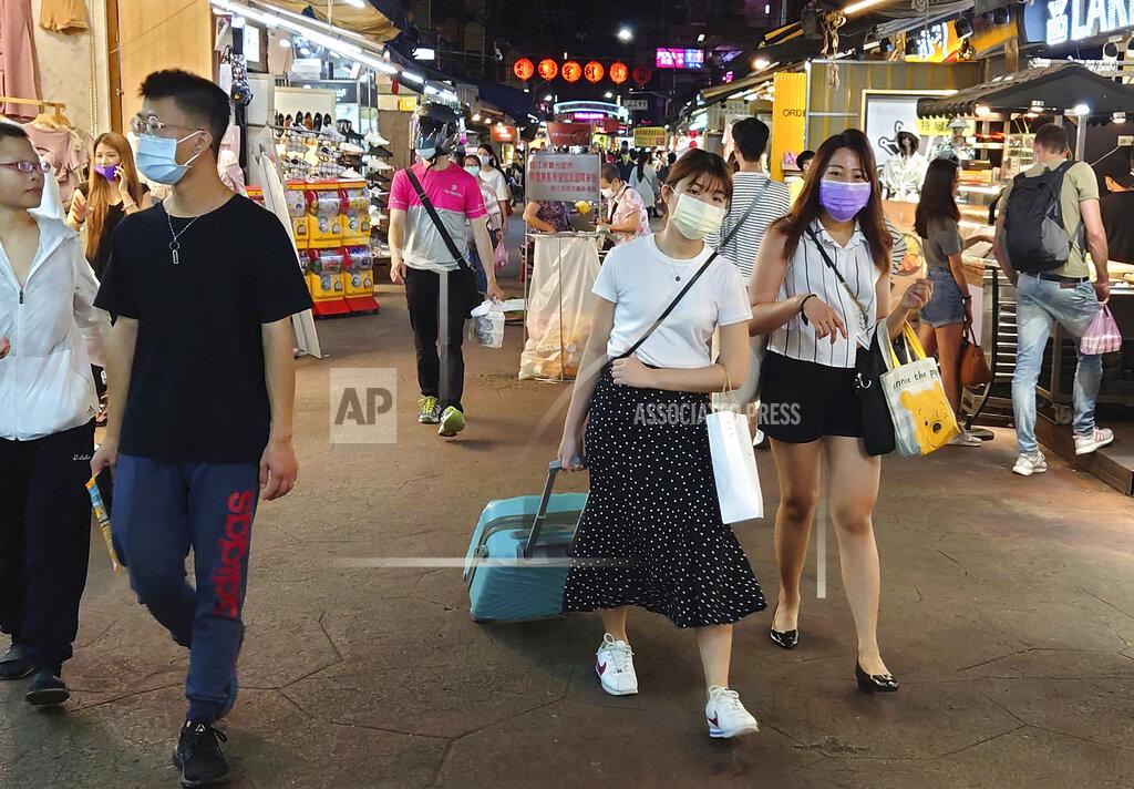 Chiang Ying-Ying People wear face masks to protect against the spread of the coronavirus at a night market in Taipei, Taiwan, Friday, May 14, 2021. (AP Photo/Chiang Ying-ying)