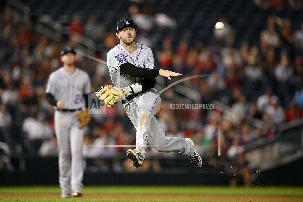 Nick Wass Colorado Rockies shortstop Trevor Story throws to first but is unable to put out Washington Nationals' Lane Thomas who singled during the sixth inning of a baseball game on Friday, Sept. 17, 2021, in Washington. Story was charged with a throwing error on the play which enabled Thomas reach second. (AP Photo/Nick Wass)