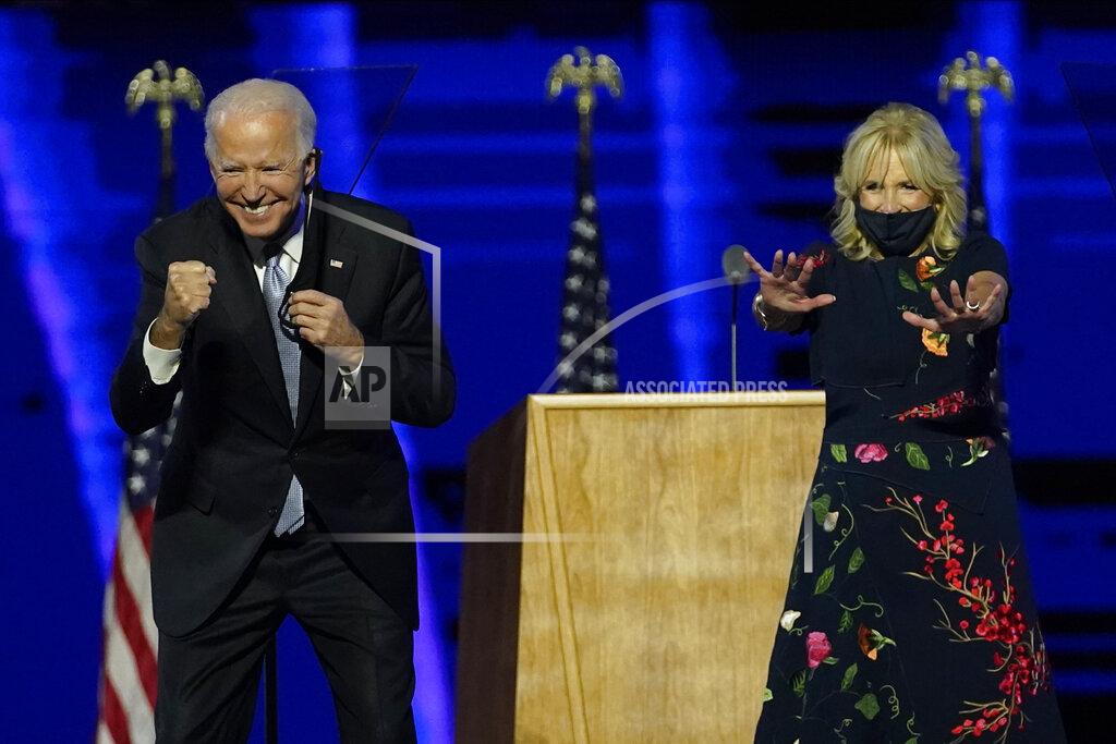 Andrew Harnik President-elect Joe Biden and wife Jill Biden gesture to supporters Saturday, Nov. 7, 2020, in Wilmington, Del. (AP Photo/Andrew Harnik, Pool)