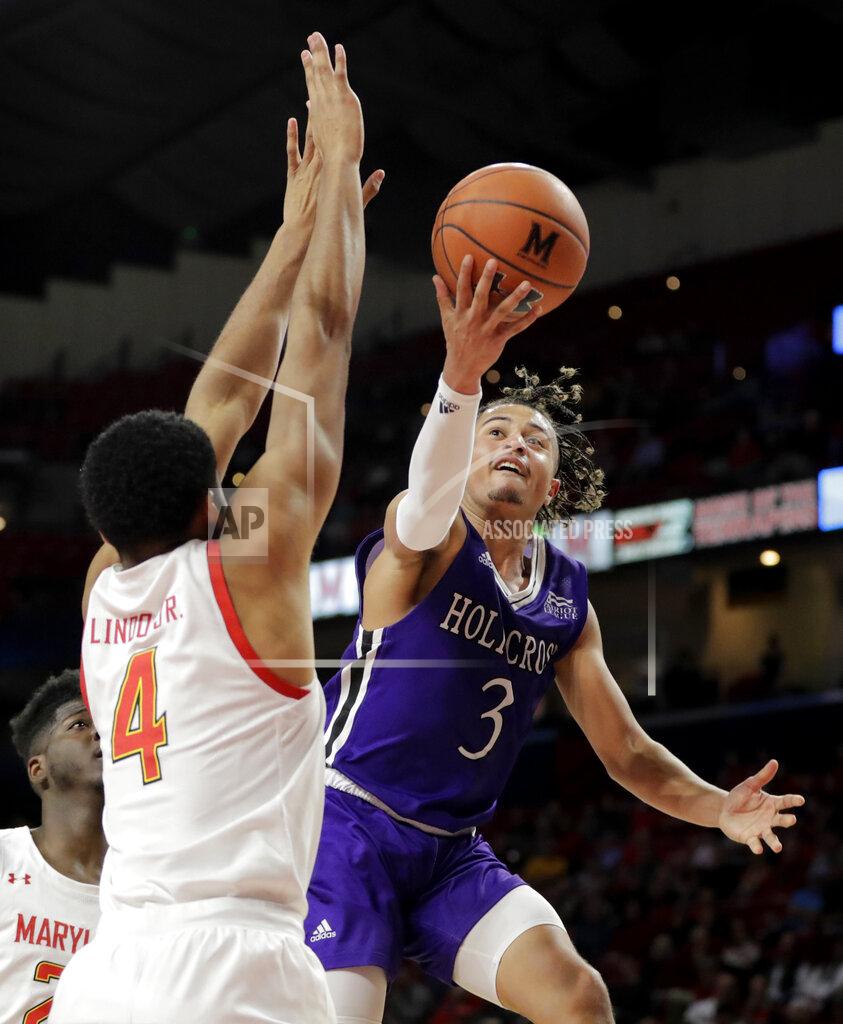 Julio Cortez Holy Cross guard Drew Lowder (3) goes up for a shot against Maryland forward Ricky Lindo Jr. (4) during the second half of an NCAA college basketball game, Tuesday, Nov. 5, 2019, in College Park, Md. Maryland won 95-71. (AP Photo/Julio Cortez)