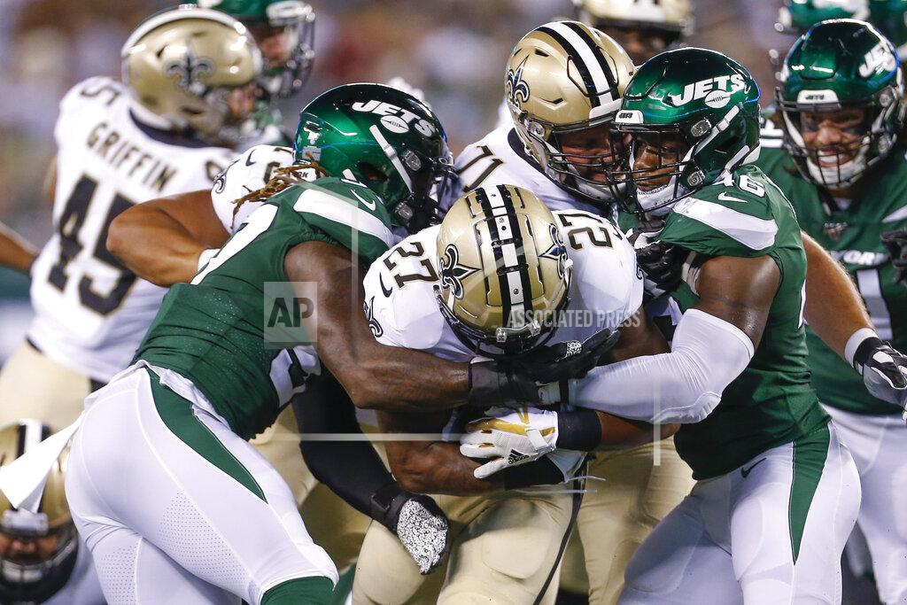 Adam Hunger New Orleans Saints' Dwayne Washington (27) is tackled by New York Jets' Neville Hewitt, right, and C.J. Mosley, left, during the first half of a preseason NFL football game Saturday, Aug. 24, 2019, in East Rutherford, N.J. (AP Photo/Adam Hunger)