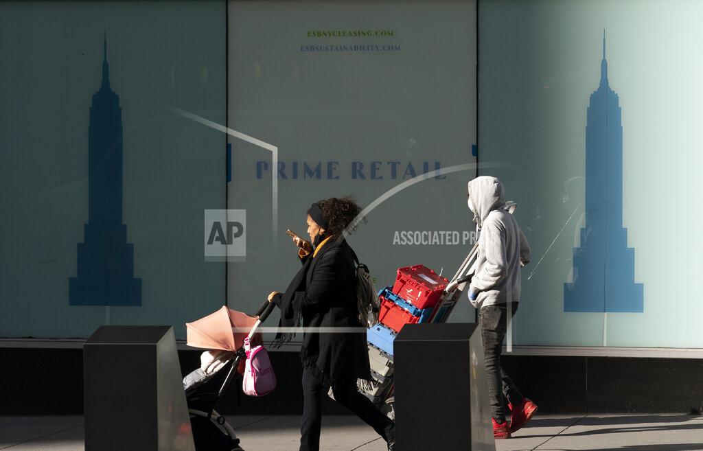 Mark Lennihan Empty retail space is available for lease in the Empire State Building, Thursday, Dec. 10, 2020, in New York. The spread of COVID-19 vaccines will power a stronger global economic recovery in 2021, the International Monetary Fund forecast Tuesday, Jan. 26, 2021. (AP Photo/Mark Lennihan)