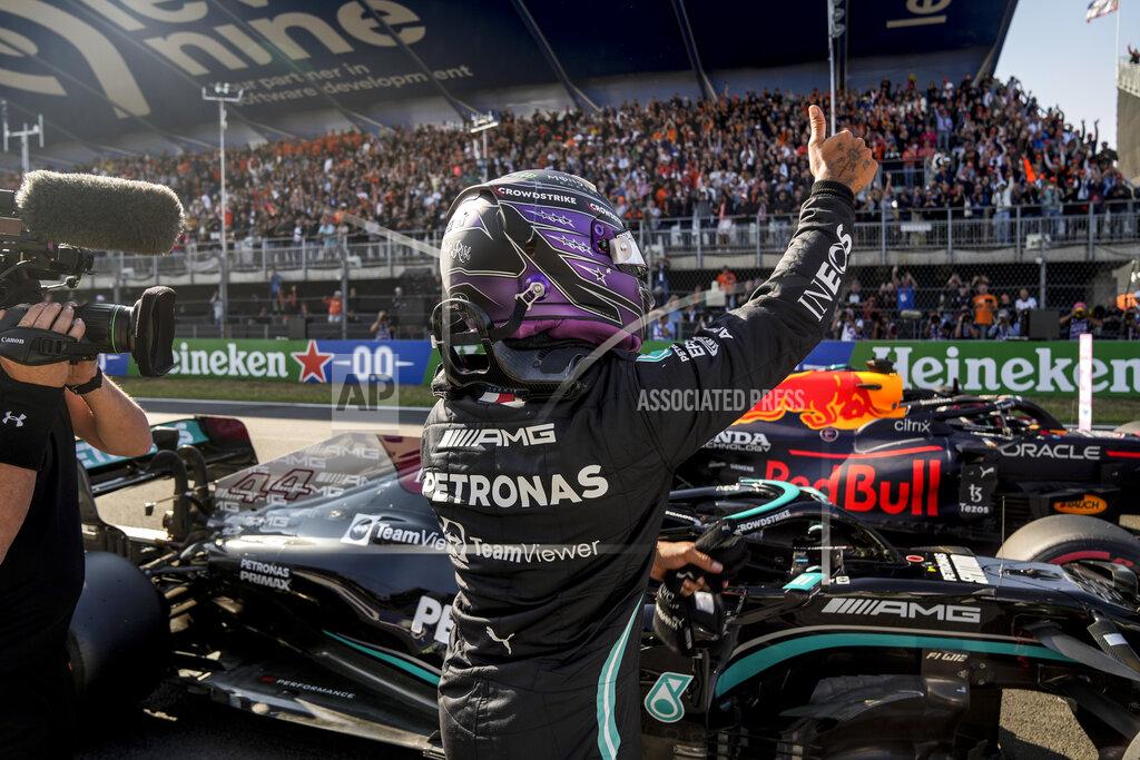Francisco Seco Mercedes driver Lewis Hamilton of Britain celebrates after setting the second fastest time in the qualifying session for Sunday's Formula One Dutch Grand Prix at the Zandvoort racetrack, Netherlands, Saturday, Sept. 4, 2021. (AP Photo/Francisco Seco, Pool)