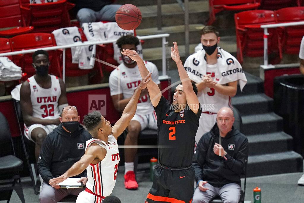 Rick Bowmer Oregon State guard Jarod Lucas (2) shoots as Utah guard Alfonso Plummer, left, defends during the first half of an NCAA college basketball game Wednesday, March 3, 2021, in Salt Lake City. (AP Photo/Rick Bowmer)