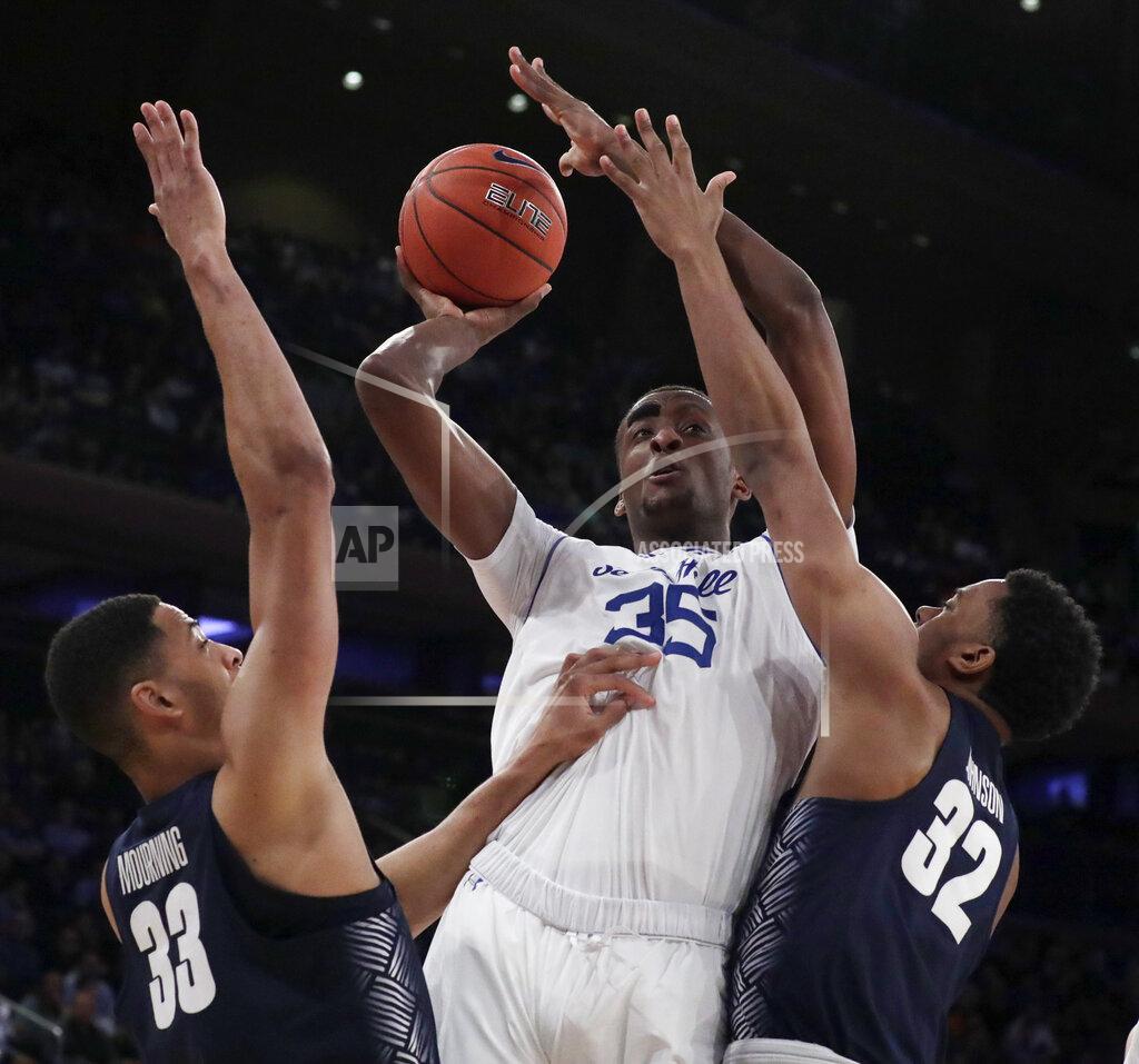 Julio Cortez Seton Hall center Romaro Gill (35) goes up for a shot against Georgetown forward Trey Mourning (33) and guard Kaleb Johnson (32) during the first half of an NCAA college basketball game in the Big East men's tournament, Thursday, March 14, 2019, in New York. (AP Photo/Julio Cortez)