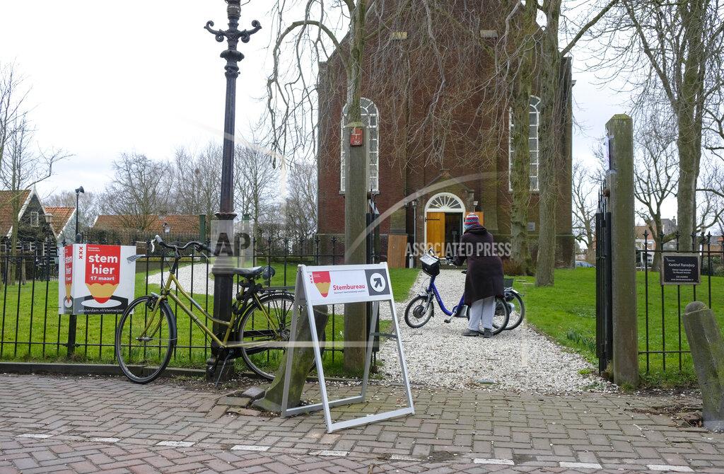 Patrick Post People vote in general elections at a church in the village of Ransdorp, near Amsterdam, Netherlands, Wednesday, March 17, 2021. Polling stations have opened opened across the Netherlands from Monday in a general election that has been spread over three days to allow people to vote safely during the coronavirus pandemic. (AP Photo/Patrick Post)