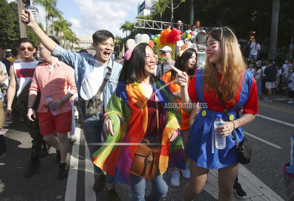 Chiang Ying-Ying Participants march through a street during a pride parade in Taipei, Taiwan, Saturday, Oct. 31, 2020. (AP Photo/Chiang Ying-ying)
