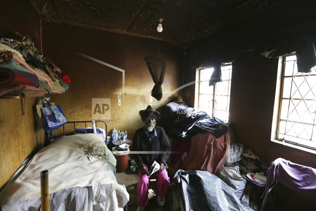 Tsvangirayi Mukwazhi An elderly man sits inside his room at the Society for the Destitute Aged care home in Harare's Highfield township, Zimbabwe, Thursday June 24, 2021. The economic ravages of COVID-19 are forcing some families in Zimbabwe to abandon the age old tradition of taking care of the elderly. Zimbabwe's care homes have experienced a 60% increase in admissions since the outbreak of the pandemic in March last year. (AP Photo/Tsvangirayi Mukwazhi)