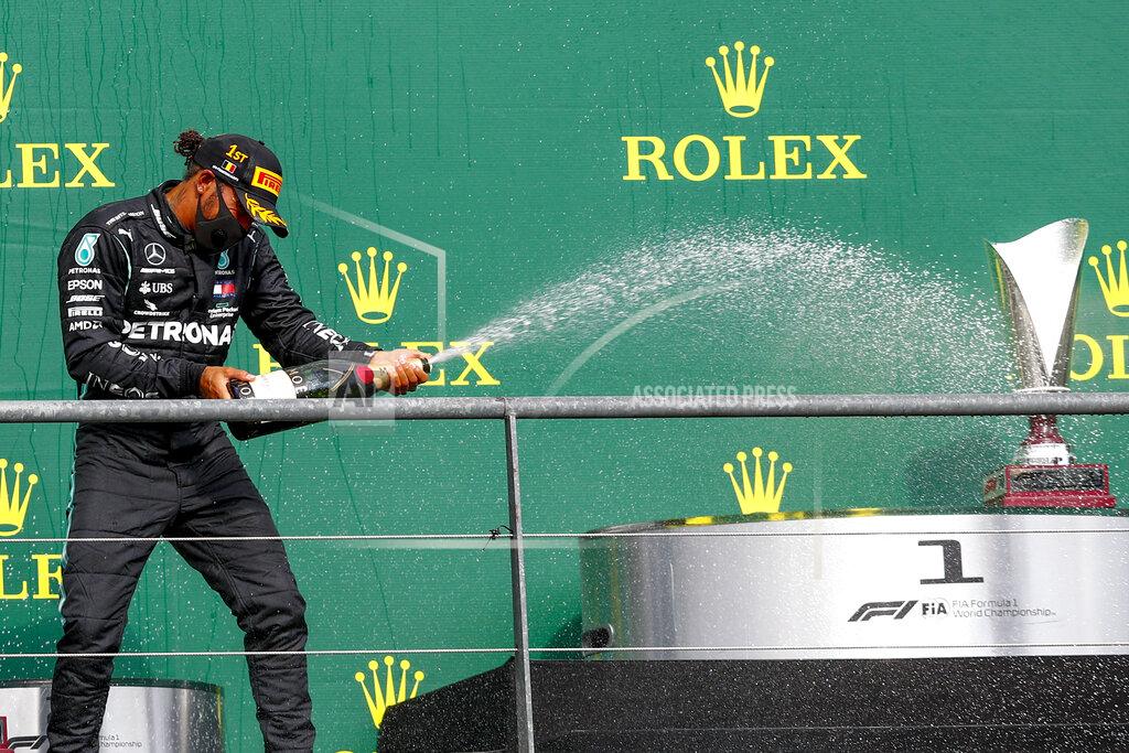 Francois Lenoir Mercedes driver Lewis Hamilton of Britain steers celebrates on the podium after winning the Formula One Grand Prix at the Spa-Francorchamps racetrack in Spa, Belgium, Sunday, Aug. 30, 2020. (Francois Lenoir/Pool Photo via AP)