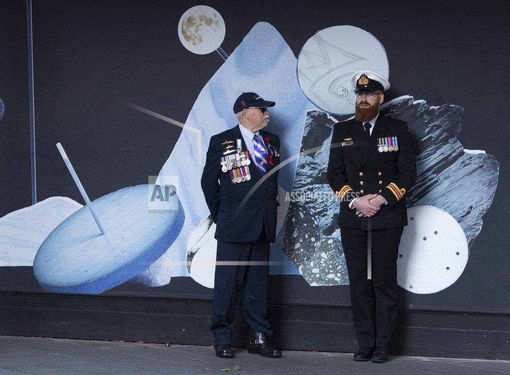 Mark Baker Veterans chat ahead of marching in the Anzac Day parade in Sydney, Australia, Sunday, April 25, 2021. Australians and New Zealanders paid tribute to their war dead Sunday as both nations prepared to withdraw from their longest war in Afghanistan. (AP Photo/Mark Baker)