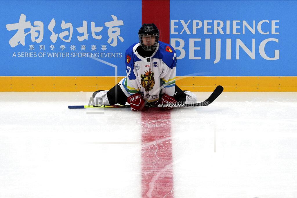 Andy Wong A Capital Institute hockey team player stretches during a practice session at the ice hockey venue set for the 2022 Beijing Winter Olympics during a test event at the National Indoor Stadium in Beijing, Thursday, April 1, 2021. Chinese capital holds 10 days test events for 2022 Beijing Winter Olympics in five different venues from April 1-10 and becomes the first city to hold both the Winter and Summer Olympics. (AP Photo/Andy Wong)