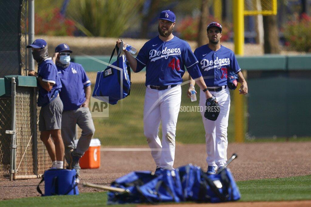 Ross D. Franklin Los Angeles Dodgers pitchers Jimmy Nelson and Scott Alexander (75) make their way on to a new practice field during a spring training baseball practice Tuesday, Feb. 23, 2021, in Phoenix. (AP Photo/Ross D. Franklin)