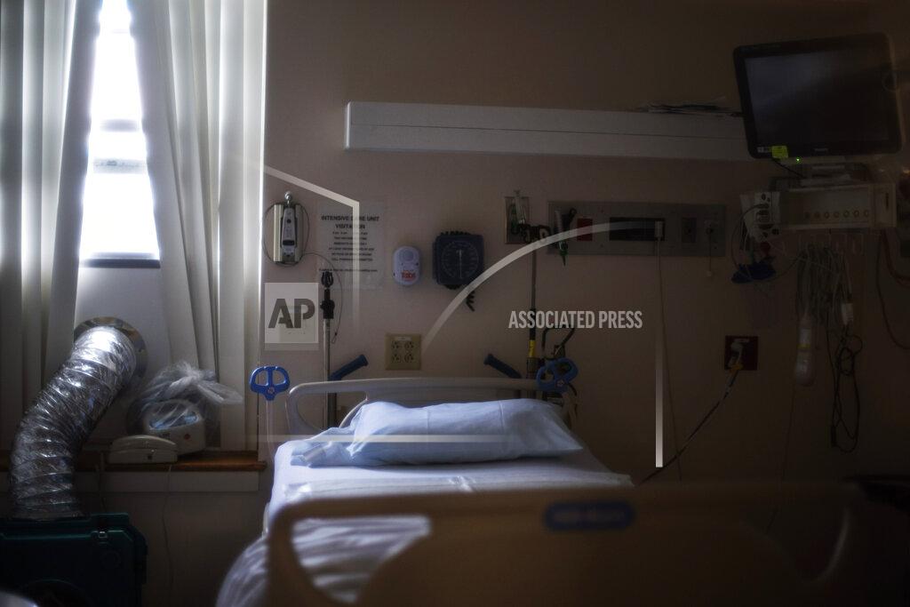David Goldman A bed sits made inside Kent Hospital's intensive care unit, which cares for the sickest of COVID-19 patients, Monday, Jan. 4, 2020, in Warwick, R.I. Kent hospital opened a field hospital on Nov. 30, just before Rhode Island's infection rate became the highest in the world. Kent Hospital was using all its beds for its sickest COVID-19 patients, and needed somewhere for the overflow. (AP Photo/David Goldman)