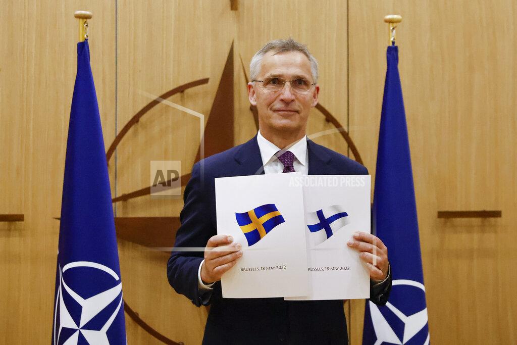 Johanna Geron NATO Secretary-General Jens Stoltenberg displays documents as Sweden and Finland applied for membership in Brussels, Belgium, Wednesday May 18, 2022. NATO Secretary-General Jens Stoltenberg said that the military alliance stands ready to seize a historic moment and move quickly on allowing Finland and Sweden to join its ranks, after the two countries submitted their membership requests. (Johanna Geron, Pool via AP)