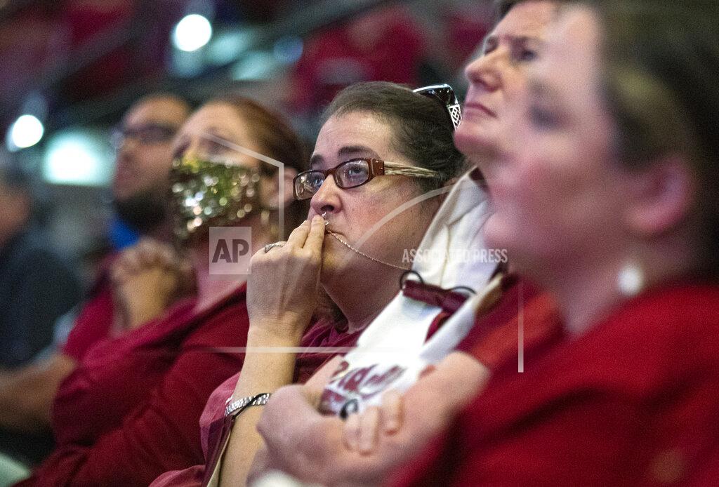 Mark Wallheiser Florida State fans listen during the service for longtime Florida State football coach Bobby Bowden, as he lies in repose at the Tucker Civic Center during a public celebration of life, Saturday, Aug. 14, 2021, in Tallahassee, Fla. Bowden became the FSU football coach in 1976, transforming the program into one of the best in the country. He coached FSU to national championships in 1993 and 1999. Bowden was 91. (AP Photo/Mark Wallheiser)