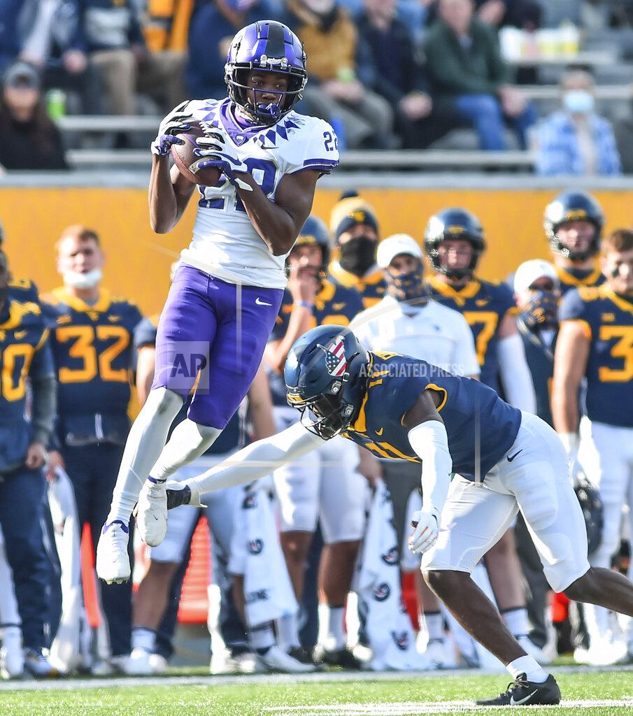 William Wotring TCU wide receiver Blair Conwright (22) makes a catch and is tackled by West Virginia safety Jake Long (22) during the second half of an NCAA college football game on Saturday, Nov. 14, 2020, in Morgantown, W.Va. (William Wotring/The Dominion-Post via AP)