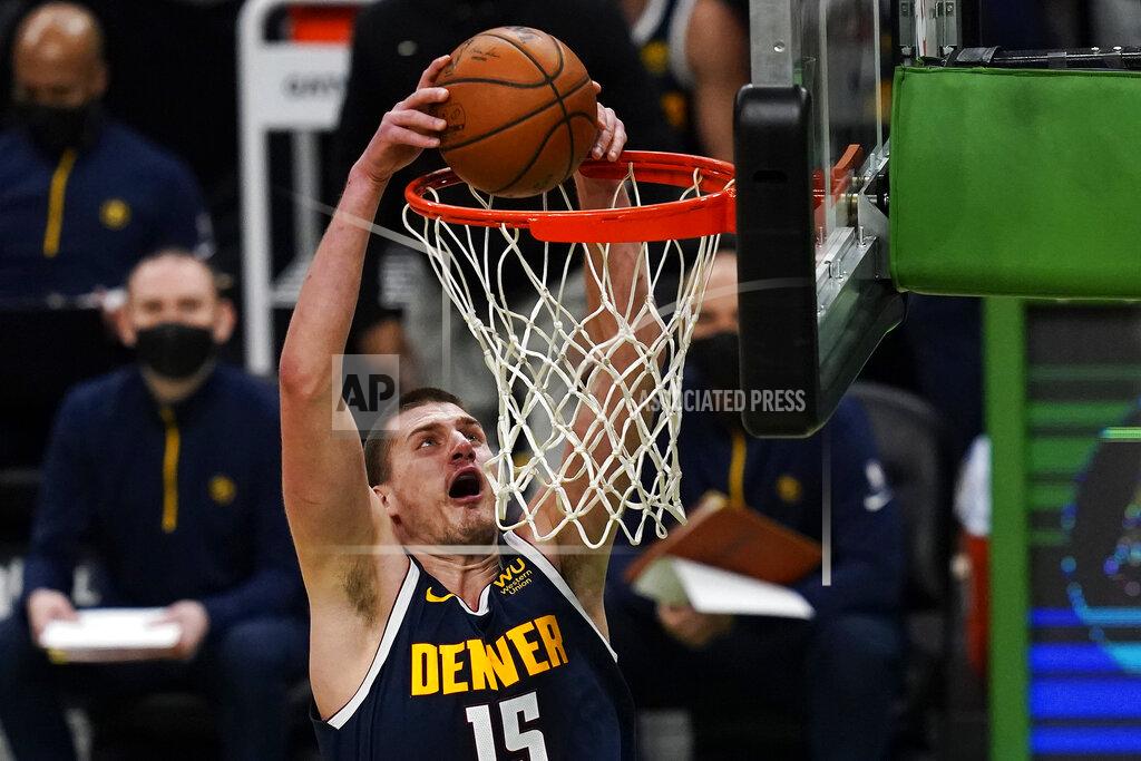 Charles Krupa Denver Nuggets center Nikola Jokic (15) slams a dunk against the Boston Celtics during the first half of an NBA basketball game, Tuesday, Feb. 16, 2021, in Boston. (AP Photo/Charles Krupa)