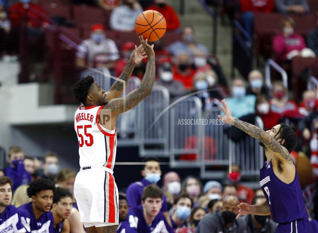 Paul Vernon Ohio State guard Jamari Wheeler, left, goes up to shoot in front of Northwestern guard Boo Buie during the first half of an NCAA college basketball game in Columbus, Ohio, Sunday, Jan. 9, 2022. (AP Photo/Paul Vernon)