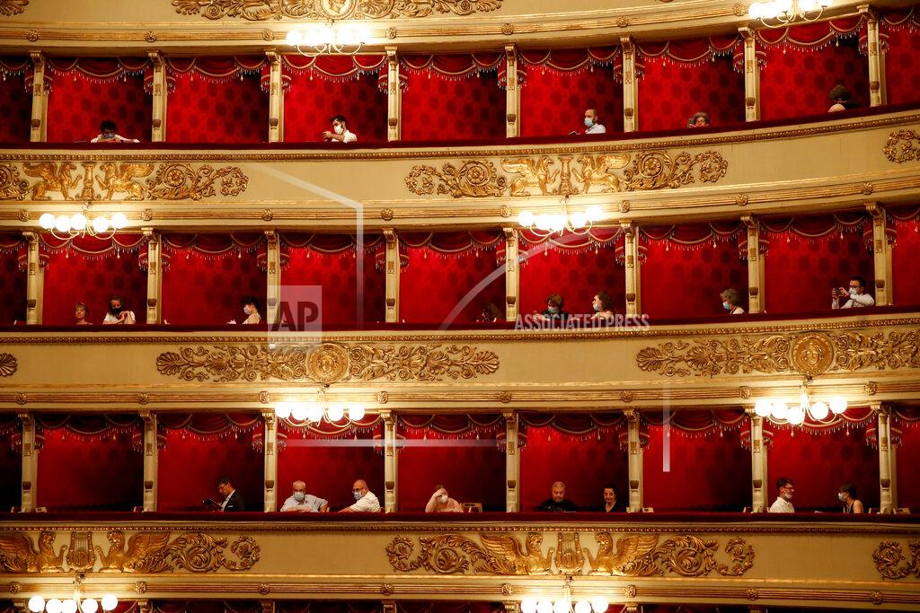 Antonio Calanni Spectators wearing masks wait for a show at La Scala theater in Milan, Italy, on Monday, July 6, 2020. The opera house reopened Monday after a four-month shutdown due to the COVID-19 restriction measures. (AP Photo/Antonio Calanni)