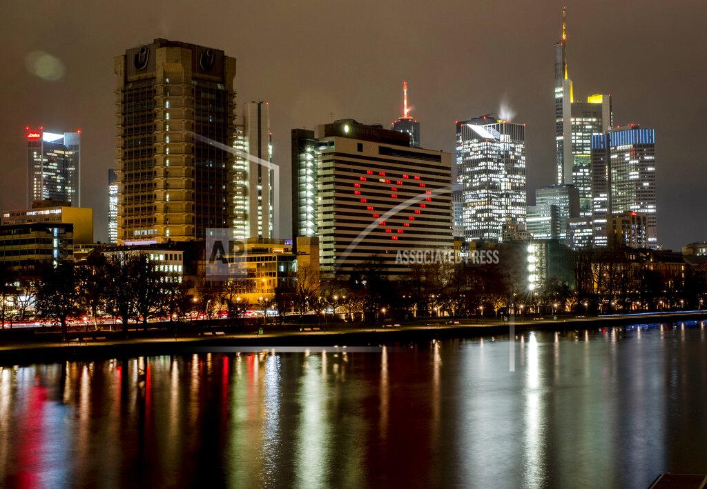 Michael Probst FILE - In this Dec. 10, 2020 file photo, a hotel has switched on the lights in some rooms to form a heart near the buildings of the banking district in in Frankfurt, Germany. More than 50,000 people have died after contracting COVID-19 in Germany, a number that has risen swiftly over recent weeks as the country has struggled to bring down infection figures. (AP Photo/Michael Probst, File)