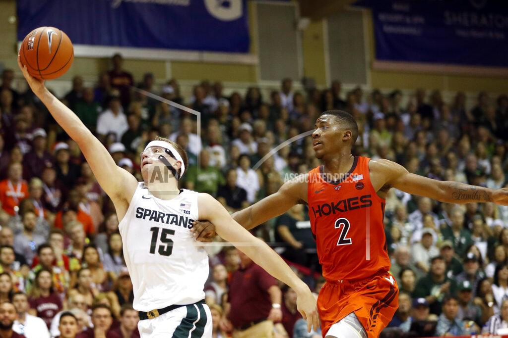 Marco Garcia Michigan State forward Thomas Kithier (15) grabs a pass over Virginia Tech guard Landers Nolley II (2) during the first half of an NCAA college basketball game Monday, Nov. 25, 2019, in Lahaina, Hawaii. (AP Photo/Marco Garcia)