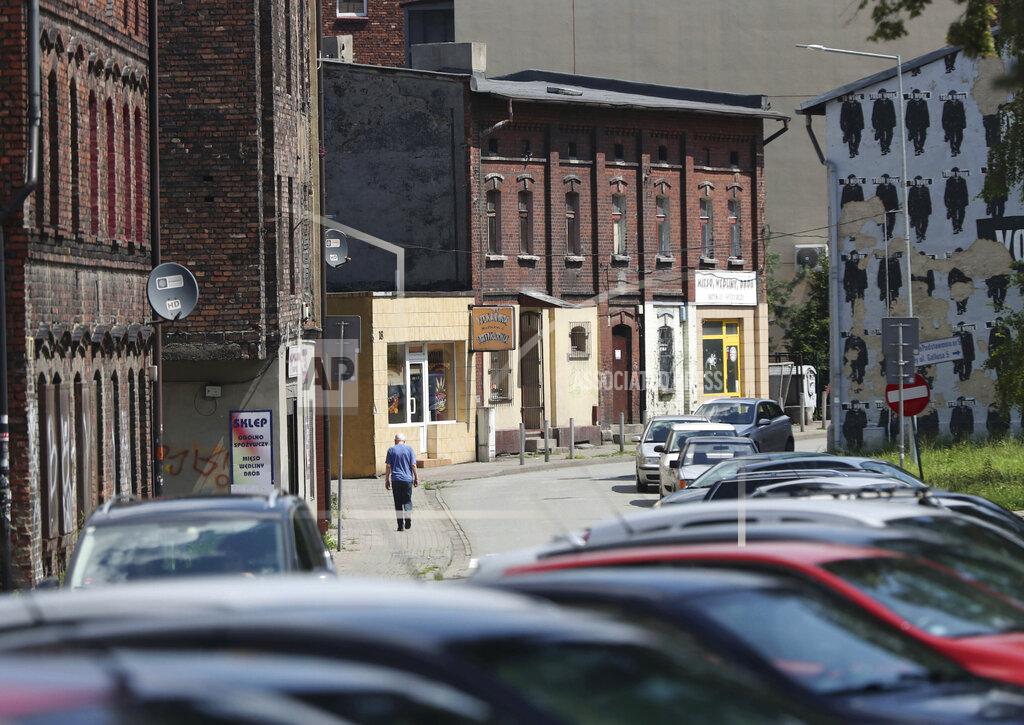 Czarek Sokolowski Cars sit outside the closed Wujek coal mine in Katowice, Poland, Saturday, July 4, 2020. The coronavirus has ripped through Poland's coal mines, forcing many to stay home from work and triggering a three-week closure of many state-run mines. (AP Photo/Czarek Sokolowski)