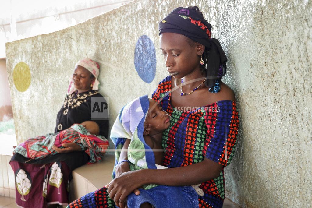 Sam Mednick Fatima Li, 20, foreground, holds her two-year-old son, Hama Sow, as he is treated with a feeding tube for malnourishment, as Hadiara Ouedraogo, left, sits with her granddaughter, Fatimata Ouedrago, 2, who has edema due to severe malnourishment, at Yalgado Ouedraogo University in Ouagadougou, Burkina Faso on Monday, June 22, 2020. In Burkina Faso one in five young children is chronically malnourished. Food prices have spiked, and 12 million of the country’s 20 million residents don’t get enough to eat. (AP Photo/Sam Mednick)