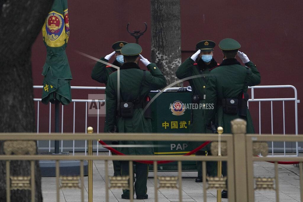 Ng Han Guan Chinese paramilitary policemen change shifts on the streets of Beijing near the Great Hall of the People on Wednesday, March 3, 2021. In a sign of confidence China has reverted back to holding its annual Congress meetings to march this year after delaying them due to the outbreak of the coronavirus last year. As usual, security has been tightened in the capital with paramilitary troops patrolling near the Great Hall of the People where the meetings are held and standing guard at subway stations. (AP Photo/Ng Han Guan)