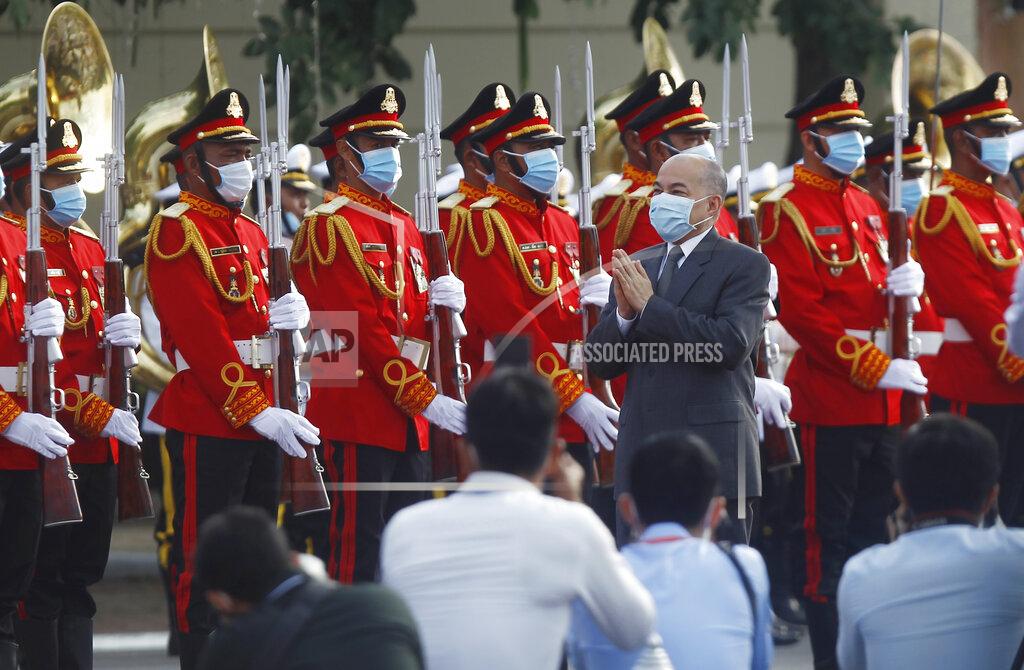 Cambodia's King Norodom Sihamoni, center, reviews the honorary troop during the country's 67th Independence Day celebration, in Phnom Penh, Cambodia, Monday, Nov. 9, 2020. (AP Photo/Heng Sinith)