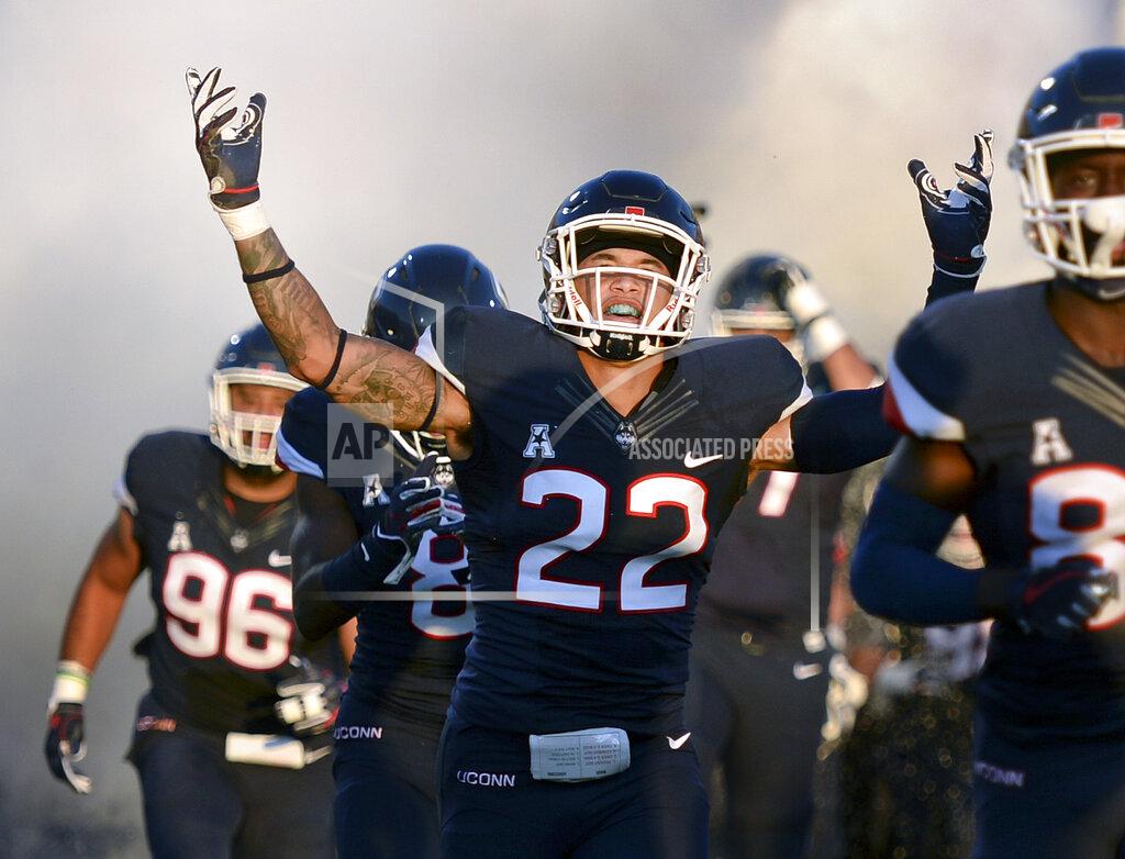 Stephen Dunn FILE - In this Aug. 30, 2018, file photo, Connecticut linebacker Eli Thomas (22) raises his arms to the crowd as his team enters the field for their season-opening NCAA college football game against Central Florida in East Hartford, Conn. Thomas, who overcame a stroke to return to school, is among the first six athletes named as finalists for the Hartford HealthCare Courage Award. (AP Photo/Stephen Dunn, File)