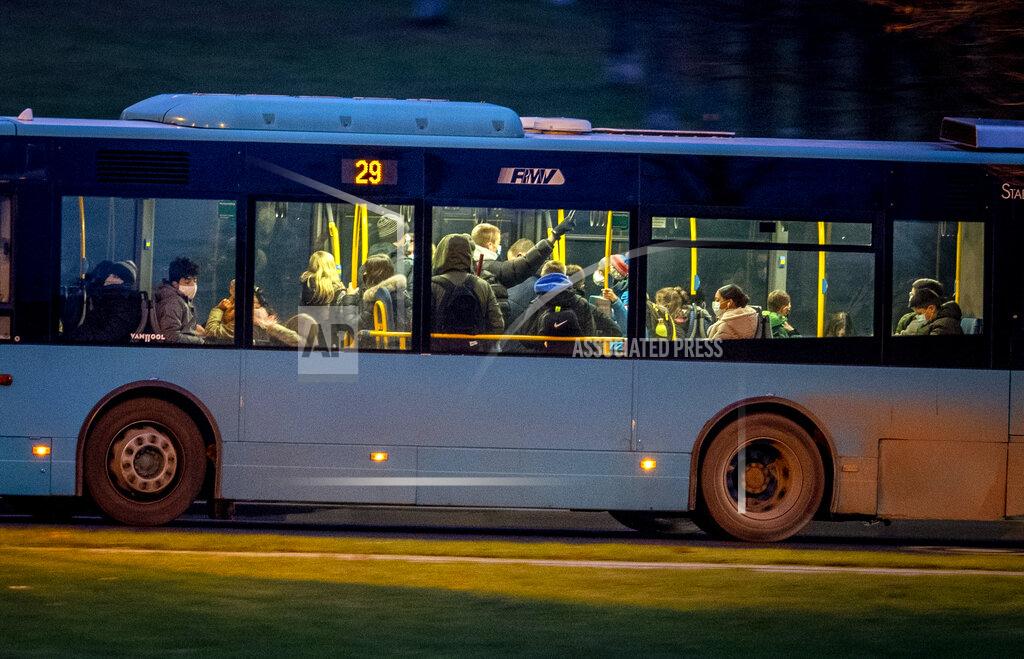 Michael Probst People drive in a bus in Frankfurt, Germany, Monday, Dec. 14, 2020. Germany goes into a lockdown on Wednesday, Dec. 16, 2020. (AP Photo/Michael Probst)
