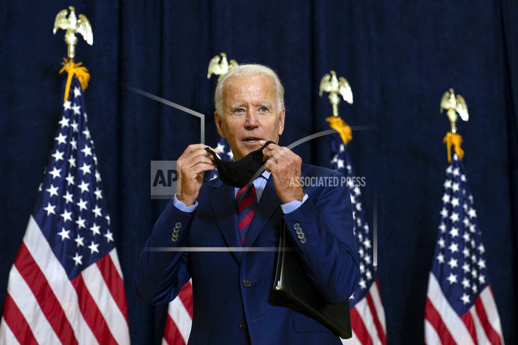Carolyn Kaster Democratic presidential candidate former Vice President Joe Biden puts on his face mask after speaking to media in Wilmington, Del., Friday Sept. 4, 2020. (AP Photo/Carolyn Kaster)