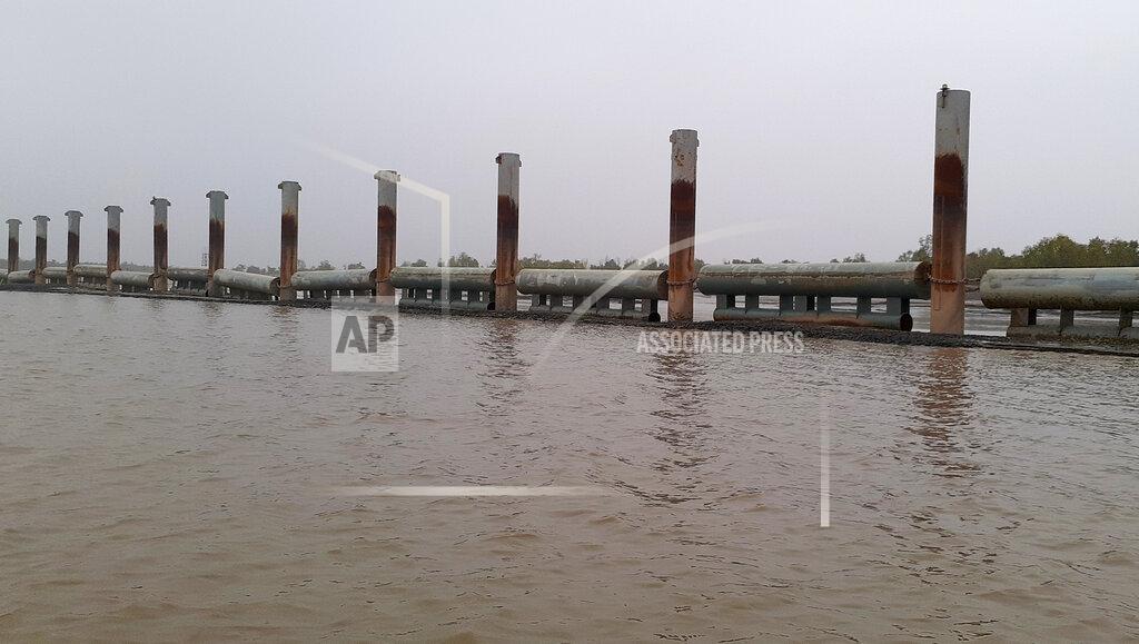 Saleh Noman FILE-In this Thursday, Dec. 19, 2019, file photo, newly built flood embankments stand near Bhasan Char, or floating island, in the Bay of Bengal, Bangladesh.. Authorities in Bangladesh have begun relocating thousands of Rohingya refugees to an isolated island despite calls by human rights groups for a halt to the process. (AP Photo/Saleh Noman)