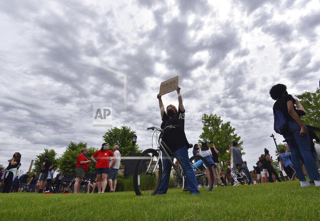 John Starks A woman holds a sign at a Black Lives Matter rally at the Peg Bond Pavilion in Batavia, Ill., Wednesday, June 3, 2020, during a protest over the death of George Floyd, a black man who was killed while in police custody in Minneapolis on May 25. (John Starks/Daily Herald via AP)