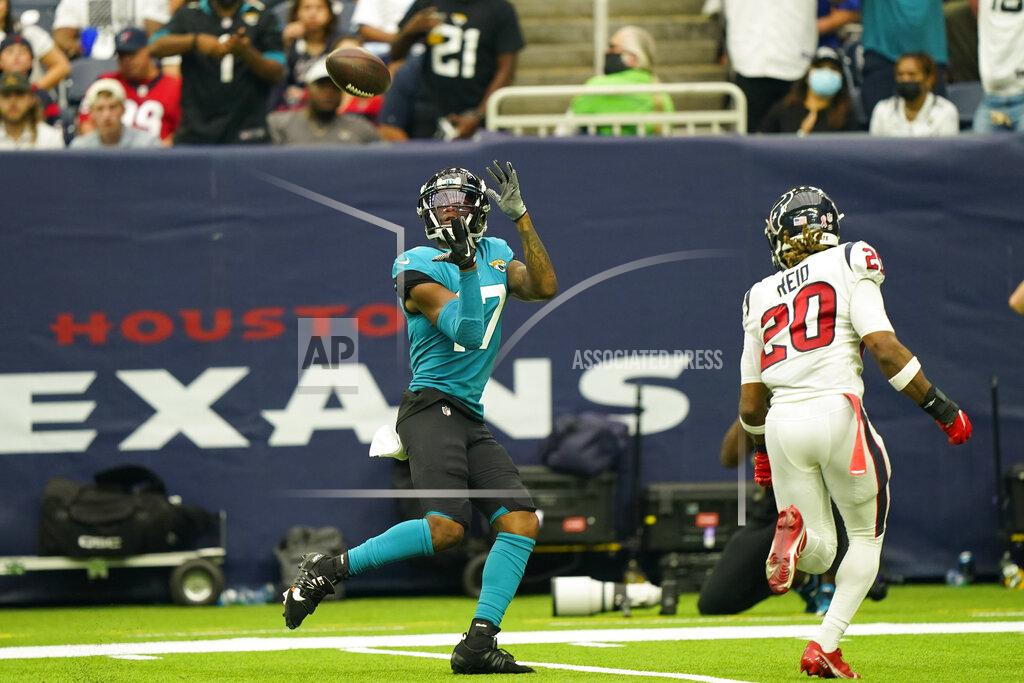 Eric Christian Smith Jacksonville Jaguars wide receiver DJ Chark Jr. (17) catches a pass for a touchdown as Jacksonville Jaguars safety Daniel Thomas (20) defends during the second half of an NFL football game Sunday, Sept. 12, 2021, in Houston. (AP Photo/Eric Christian Smith)