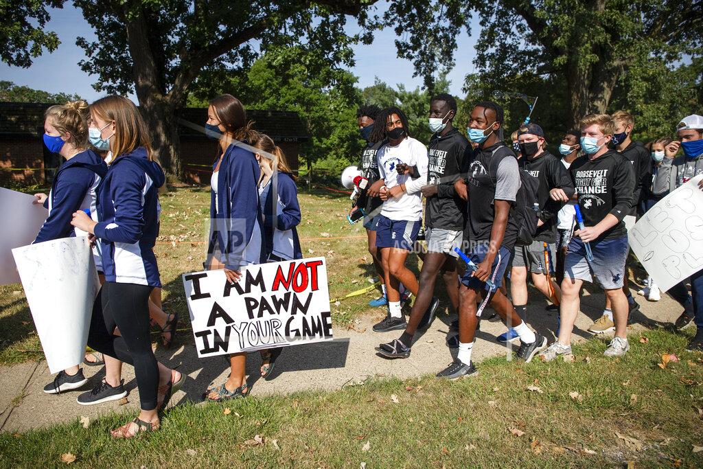 Olivia Sun Des Moines Public School students and supporters march from Roosevelt High School to the Governor's Mansion at Terrace Hill to protest the cancellation of fall and winter extracurriculars on Sept. 7, 2020, in Des Moines, Iowa. All in-person activities were suspended this month as the district's classroom instruction remains virtual. (Olivia Sun/The Des Moines Register via AP)