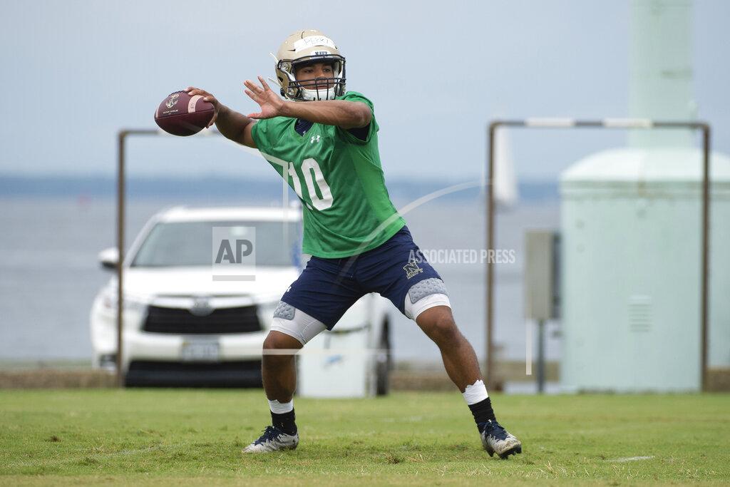 Tommy Gilligan FILE - In this Aug. 2, 2019, file photo, Navy quarterback Malcolm Perry (10) looks to throw during NCAA college football training camp in Annapolis, Md. Much of the team’s success could hinge on how well Perry is able to execute this offense. He completed nine of 25 pass attempts for 222 yards with two touchdowns and an interception over 13 games in 2018.(AP Photo/Tommy Gilligan, File)