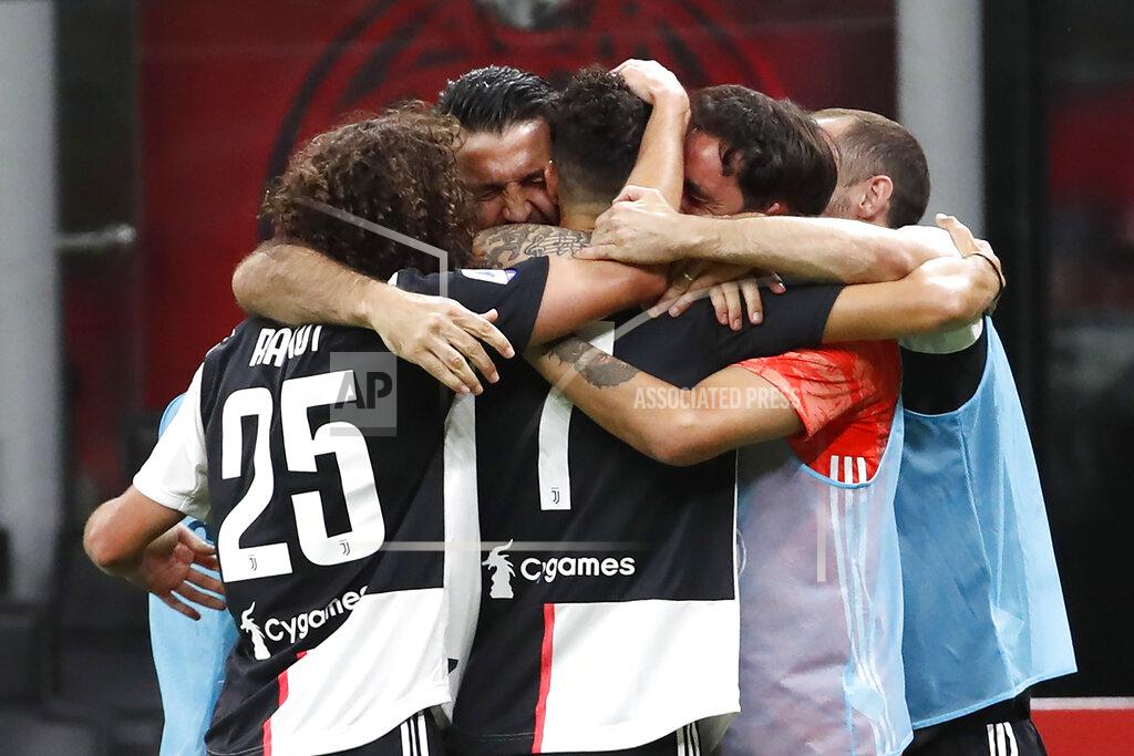 Antonio Calanni Juventus' Cristiano Ronaldo, center, celebrates with his teammates his goal against AC Milan during the Serie A soccer match between AC Milan and Juventus at the San Siro stadium, in Milan, Italy, Tuesday, July 7, 2020. (AP Photo/Antonio Calanni)
