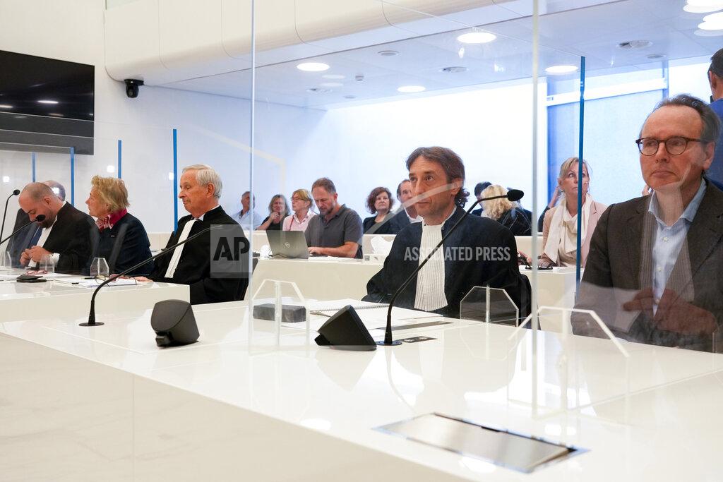 Peter Dejong Rob Meijer, third from left, lawyer for the Crimean museums and Paul Loeb, lawyer for the Allard Pierson Museum, center right, wait for the presiding judge to read the verdict in a Dutch appeals court in Amsterdam, Tuesday Oct. 26, 2021, on ownership of a trove of Crimean historical artifacts that were loaned to an Amsterdam museum shortly before Russia annexed the region. A lower court ruled in 2016 that the treasures should be handed to the Ukrainian government. (AP Photo/Peter Dejong)