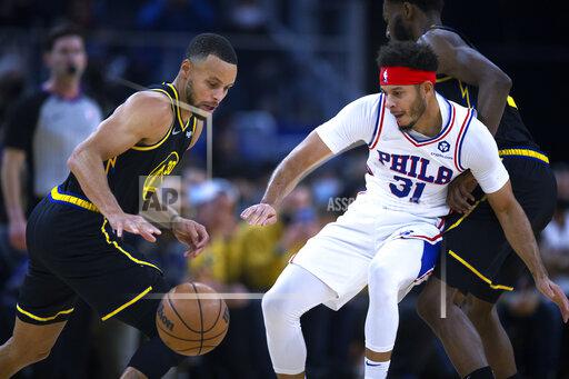 Golden State Warriors guard Stephen Curry (30) attempts to drive past Philadelphia 76ers guard Seth Curry (31) during the first quarter of an NBA basketball game Wednesday, Nov. 24, 2021, in San Francisco. (AP Photo/D. Ross Cameron)