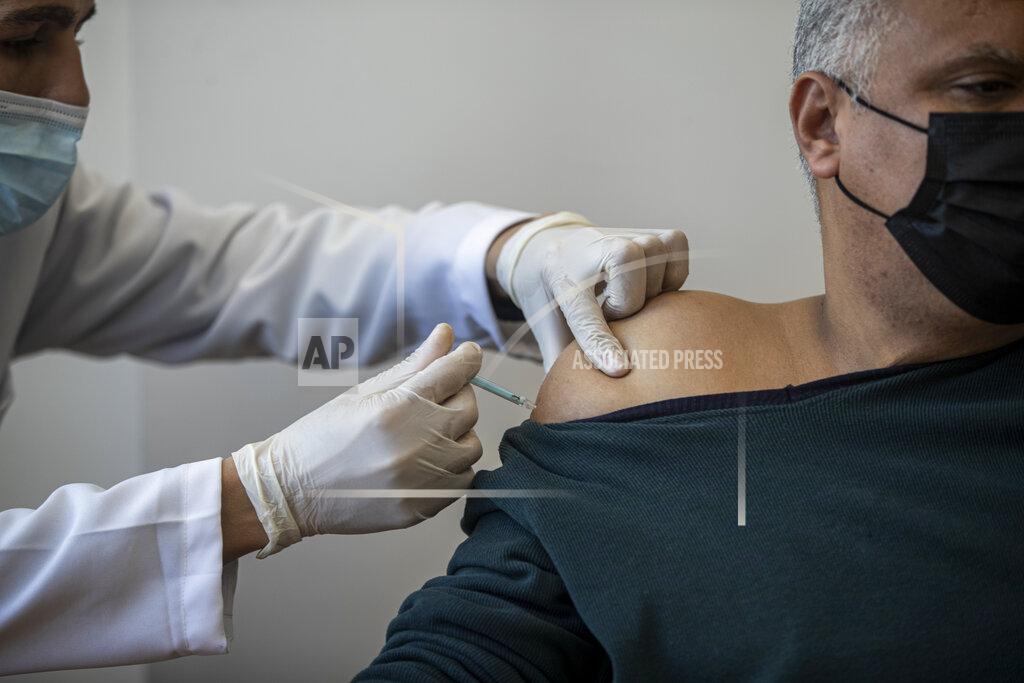 Khalil Hamra A Palestinian man receives a shot of the Russian-made Sputnik V coronavirus vaccine, at an UNRWA clinic in Gaza City, Wednesday, March 17, 2021. The Palestinian Authority says it will receive 62,000 coronavirus vaccine doses through a World Health Organization partnership designed to help poor countries.(AP Photo/Khalil Hamra)