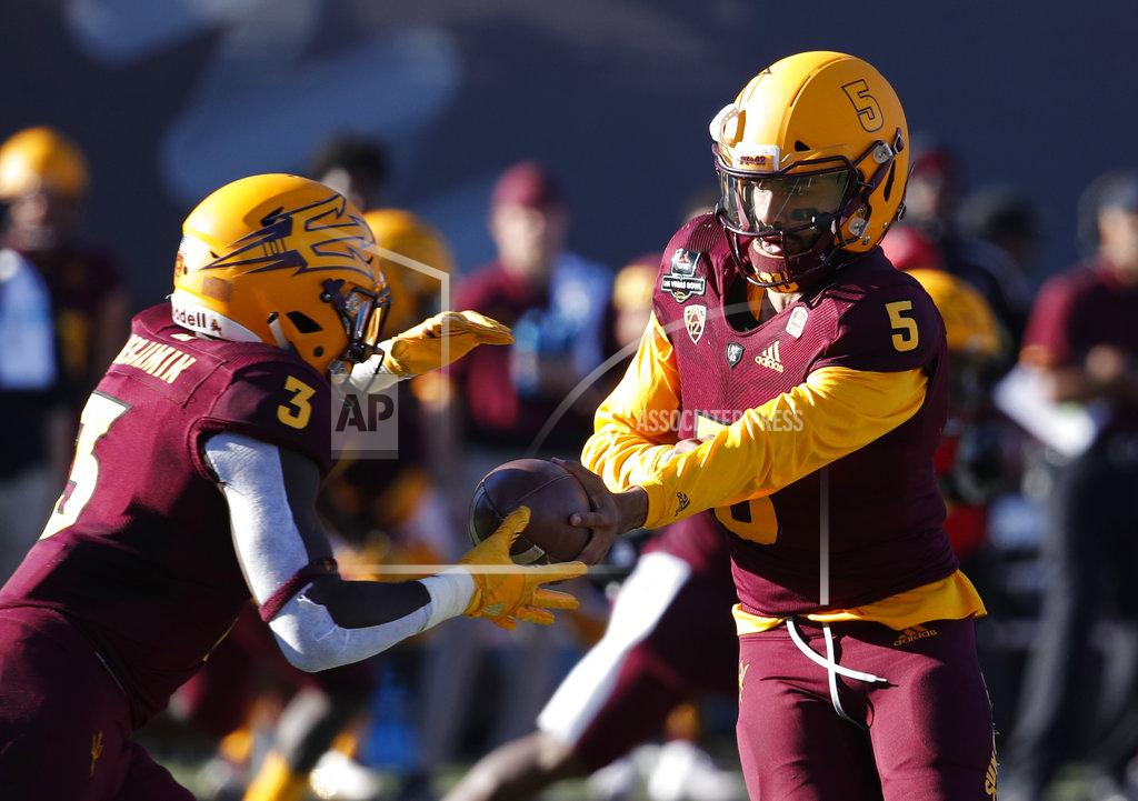 John Locher Arizona State quarterback Manny Wilkins (5) hands the ball off to running back Eno Benjamin (3) during the first half of the Las Vegas Bowl NCAA college football game against Fresno State, Saturday, Dec. 15, 2018, in Las Vegas. (AP Photo/John Locher)