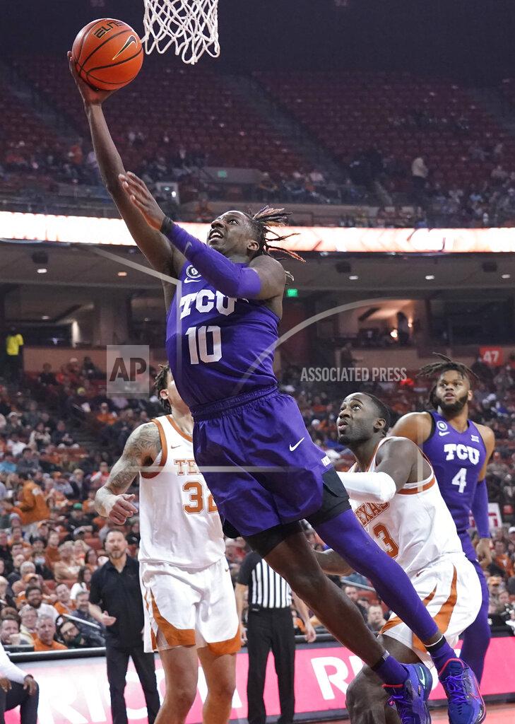 Chuck Burton TCU guard Damion Baugh (10) drives past Texas forward Christian Bishop (32) and guard Courtney Ramey (3) during the first half of an NCAA college basketball game in Austin, Texas, Wednesday, Feb. 23, 2022. (AP Photo/Chuck Burton)