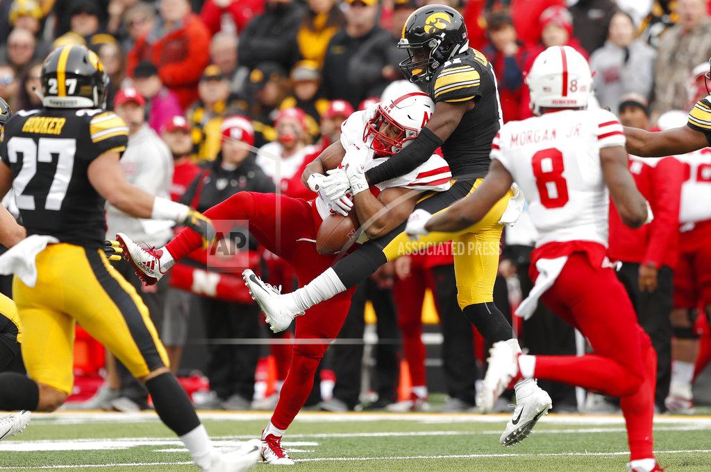 Charlie Neibergall Iowa defensive back Michael Ojemudia (11) breaks up a pass intended for Nebraska running back Devine Ozigbo, center, during the first half of an NCAA college football game, Friday, Nov. 23, 2018, in Iowa City, Iowa. (AP Photo/Charlie Neibergall)