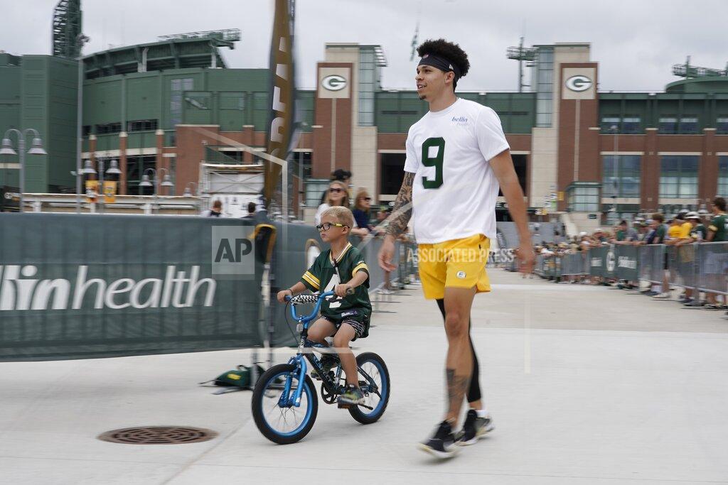 Morry Gash Green Bay Packers' Christian Watson walks to the NFL football team's practice field Wednesday, July 27, 2022, in Green Bay, Wis. (AP Photo/Morry Gash)