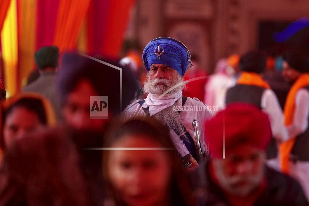 Channi Anand Sikh devotees, arrive to offer prayers during celebrations to mark the birth anniversary of the first Sikh Guru, Guru Nanak Dev, at a Gurudwara, or Sikh temple, in Jammu, India, Monday, Nov.30, 2020. India is second behind the U.S. in total coronavirus cases. Its recovery rate is nearing 94%. (AP Photo/Channi Anand)